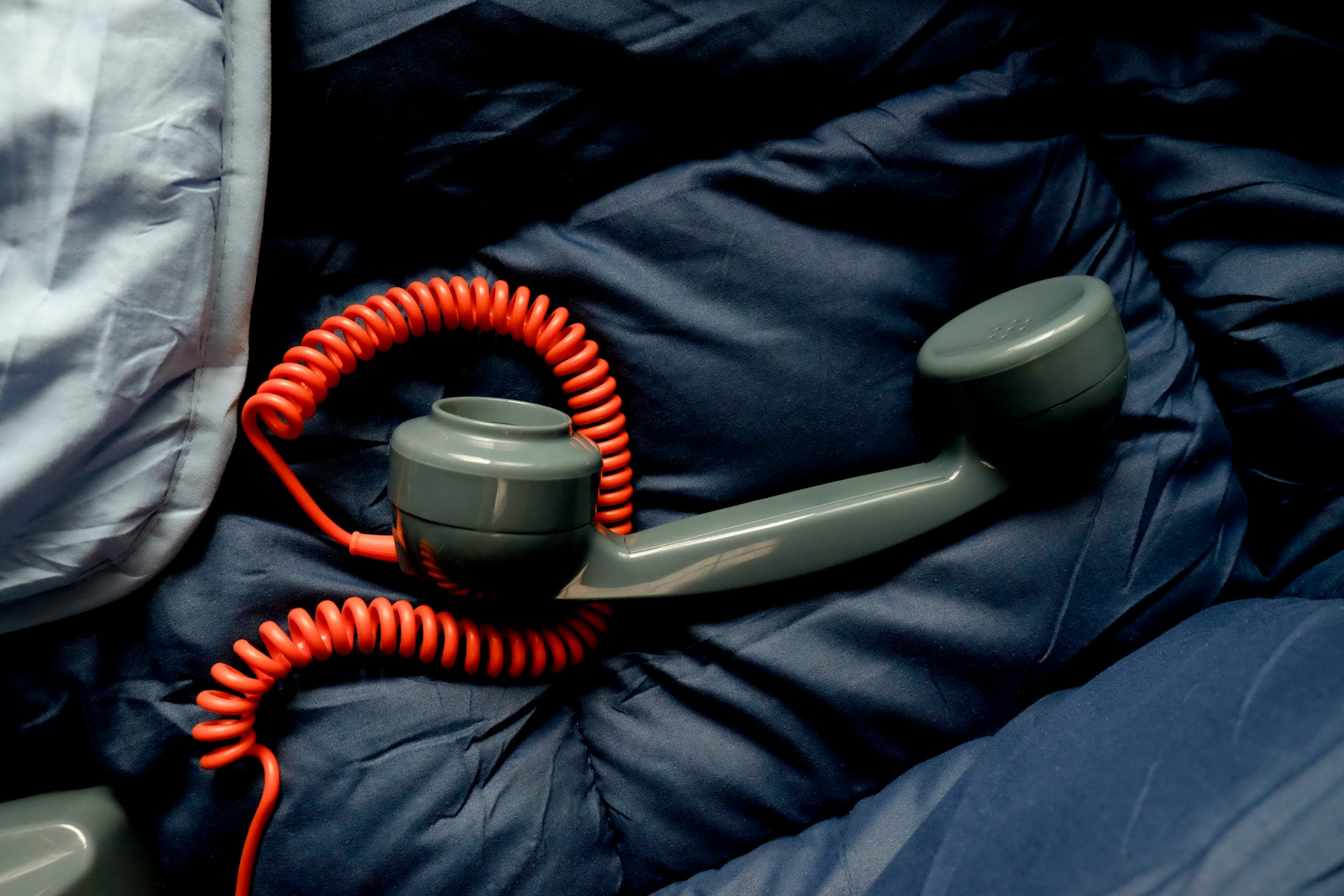 Telephone receiver on bed
